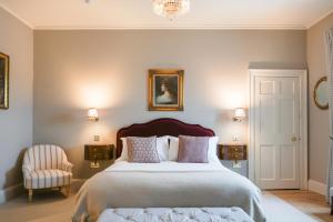 a bedroom with a large bed and a chair at The Townhouse, Leith in Edinburgh +34 photos