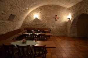 a dining room with tables and a cross on the wall at Gäste- und Tagungshaus Benediktinerabtei Plankstetten in Berching