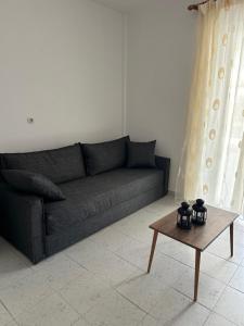 a living room with a couch and a coffee table at Seaside Paralio Apartment in Astros