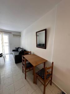 a living room with a table and a couch at Seaside Paralio Apartment in Astros