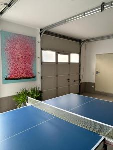 a garage with a ping pong table in it at Habicht Ferienhaus in Arnbruck