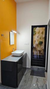 a bathroom with a white sink on a counter at Moms homestay 3 Bedrooms in Vagamon