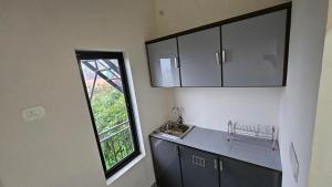 a kitchen with a counter top and a window at Moms homestay 3 Bedrooms in Vagamon +5 photos