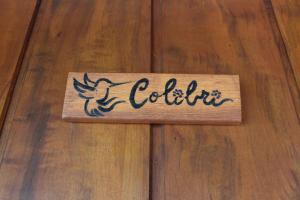 a sign on a wooden floor with a bird on it at Le Refuge Suites in Ilhabela