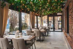 a restaurant with tables and chairs and christmas lights at Lubhotel in Lublin