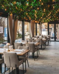 a restaurant with tables and chairs and lights at Lubhotel in Lublin