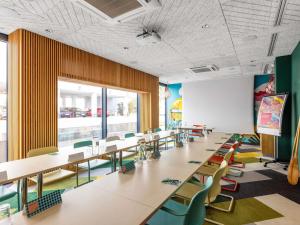 a classroom with tables and chairs in a classroom at ibis Styles Warszawa Centrum in Warsaw