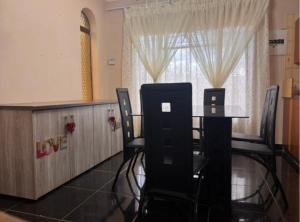 a room with a table and chairs and a window at Amatis House in Mokopane +6 photos