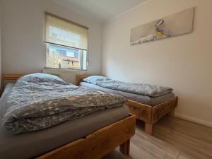 a bedroom with two beds and a window at Harzhaus Ida in Elbingerode
