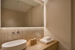 a bathroom with a white sink and a mirror at September Athens Residences in Athens +94 photos