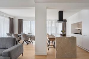 a kitchen and living room with a table and chairs at September Athens Residences in Athens