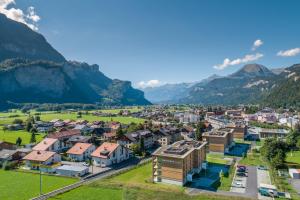 an aerial view of a small town in the mountains at SWISSPEAK Resorts by Pierre & Vacances Premium Meiringen in Meiringen
