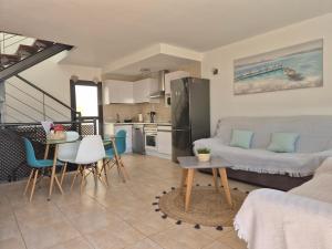 a kitchen and living room with a couch and a table at Casa en Cotillo Lagos with Free Wifi & Netflix in El Cotillo