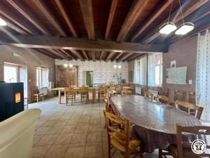 a large dining room with a large table and chairs at La Maison du Parc in Les Maillys