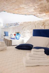 a bedroom with a bed with blue and white furniture at Tropea Belle Époque in Tropea