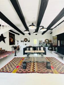 a living room with a couch and a rug at Maison Quercus in Vaylats