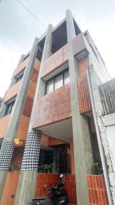a motorcycle parked in front of a building at Hakon Canggu Boutique Hostel in Canggu +2 photos