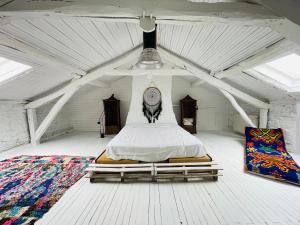 a large white room with a bed in a tent at Maison Quercus in Vaylats