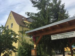 a yellow building with a sign in front of it at Fewo 4 in Markkleeberg