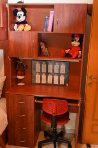 a desk with a red chair in a bedroom at SUMMER Home in Agios Nikolaos