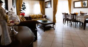 a living room with a couch and a table at SUMMER Home in Agios Nikolaos