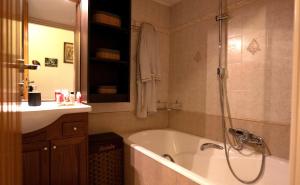 a bathroom with a bath tub and a sink at SUMMER Home in Agios Nikolaos
