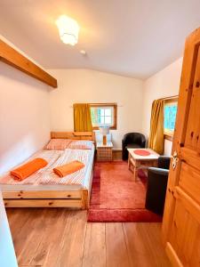 a bedroom with two beds and a living room at Privates Ferienhaus mit großem Garten in Rauen