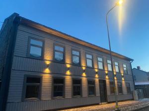 a building with lights on the side of it at A33 central studio aparthotel in Liepāja