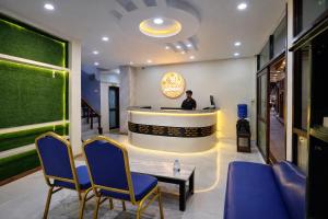 a man standing at a bar in a lobby at FUNKY MONKEY- A Hostel, Hotel and Apartment in Kathmandu