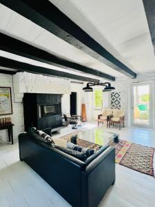 a living room with a couch and a fireplace at Maison Quercus in Vaylats +16 photos
