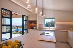 a kitchen with a table and a view of a pool at Finca Son Cladera in Sa Pobla