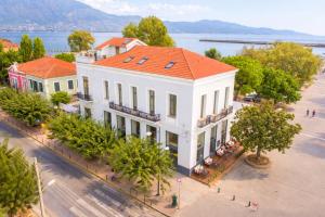 an overhead view of a white building with an orange roof at Panellinion Luxury Rooms in Kalamata