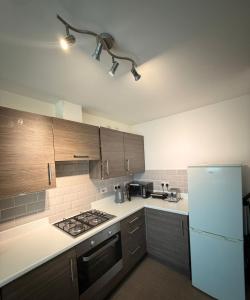 a kitchen with a stove and a refrigerator at Springfield garden-Celtic park in Glasgow