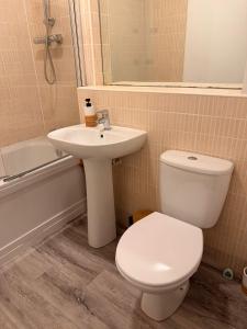 a bathroom with a toilet and a sink at Springfield garden-Celtic park in Glasgow