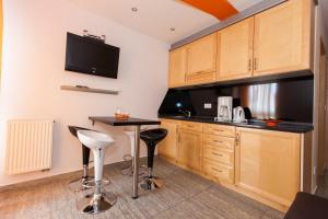 a small kitchen with a table and a tv at Apartment Crikvenica 15 in Sopaljska