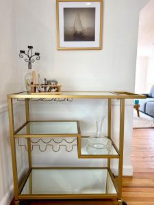 a glass shelf in a living room with a table at Peaceful Redding Cottage Retreat in Redding