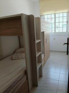 a bedroom with a bunk bed and a room with a window at Apartamento en la playa in Cunit