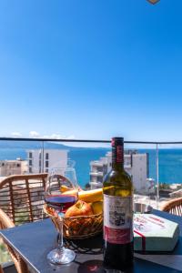 a bottle of wine sitting on a table with a glass at Seaview Deda 02 in Sarandë