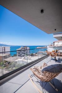 a balcony with chairs and a view of the ocean at Seaview Deda 02 in Sarandë