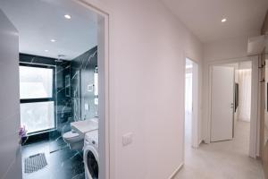 a bathroom with a toilet and a sink and a window at Seaview Deda 02 in Sarandë +56 photos
