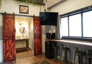 a bar with wooden doors in a room with a sink at Rivers Edge Lofts - Unit 5 in Niles +30 photos