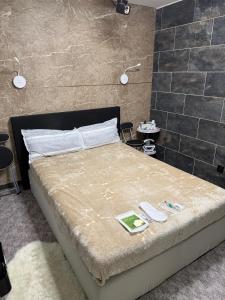 a bedroom with a large bed with two lamps on the wall at WKI Company in Mannheim