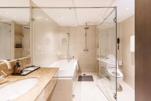 a bathroom with a tub and a sink and a toilet at S15 Sukhumvit Hotel in Bangkok +52 photos