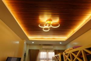 a ceiling fan in a room with a wooden ceiling at Balay Buenavista in Magdalena