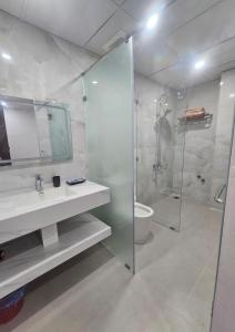 a bathroom with a shower and a sink and a toilet at The Dang's Home in Lao Cai in Pho Mới +91 photos