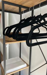 a shelf filled with black clothes at Casa PIVA 781 in Chioggia