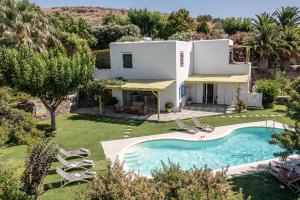 an aerial view of a villa with a swimming pool at Palatiana Agriturismo-Philoxenia Cottages Retreat in Galini