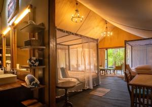 a bedroom with a canopy bed in a room at Tribe Yala - Luxury Camping in Yala