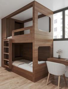 a room with a bunk bed with a desk and a chair at The Dang's Home in Lao Cai in Pho Mới