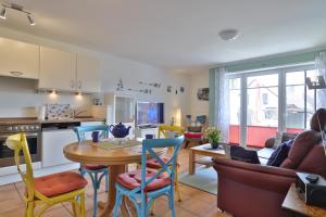 a kitchen and living room with a table and chairs at 2 Zimmer Appartement Poseidon in Boltenhagen +23 photos